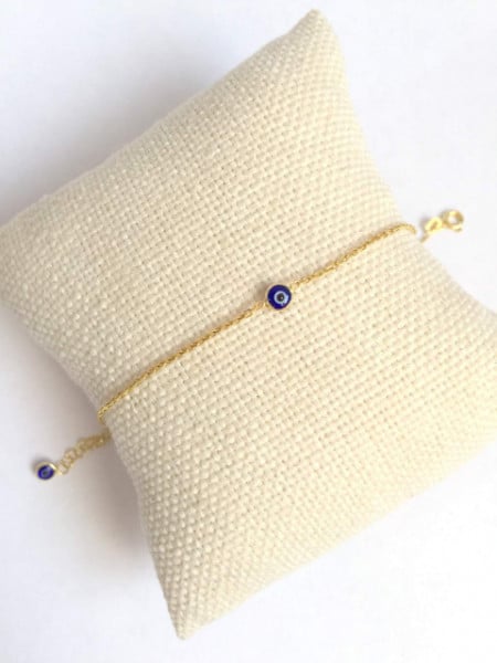 Gold-plated sterling silver 925 bracelet featuring a single dark blue evil eye bead on a delicate chain.