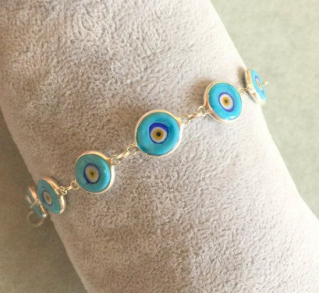 Turquoise evil eye beaded bracelet with sterling silver links and handmade vibrant beads, embodying Turkish tradition and elegance for wholesale buyers.