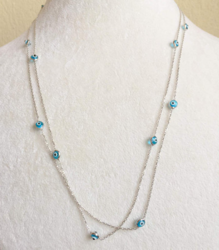 Long chain necklace featuring Turkish blue evil eye beads on sterling silver, ideal for layering and showcasing elegance with cultural significance.
