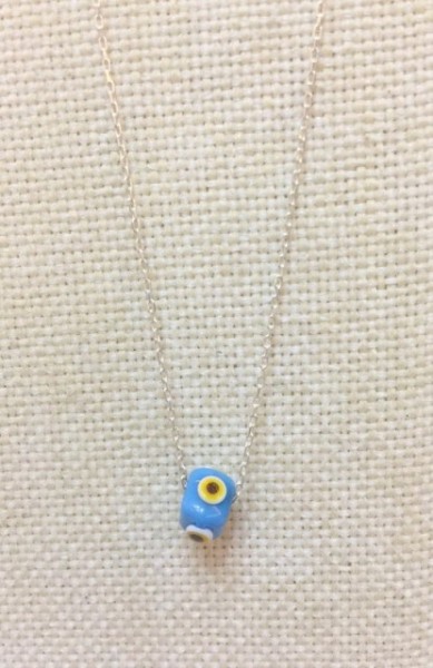 Turkish handmade evil eye bead necklace with a turquoise bead on a sterling silver chain. Elegant and protective design.