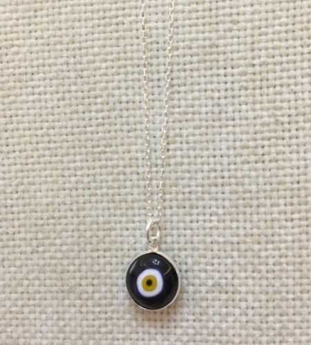 Black evil eye bead necklace with a sterling silver chain and handcrafted glass pendant.