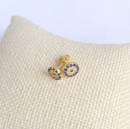 Gold-plated sterling silver evil eye stud earrings adorned with blue and white stones, a symbol of protection and style.