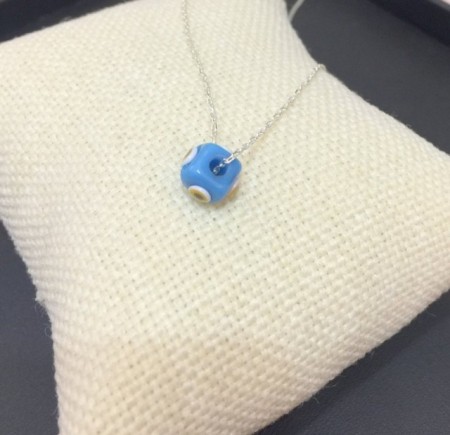 Turkish handmade evil eye bead necklace with a turquoise bead on a sterling silver chain. Elegant and protective design.