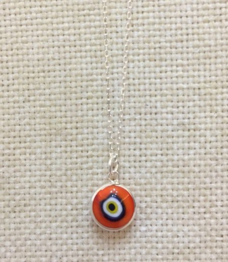 Red Nazar Boncugu evil eye necklace featuring a vibrant glass bead on a sterling silver chain.