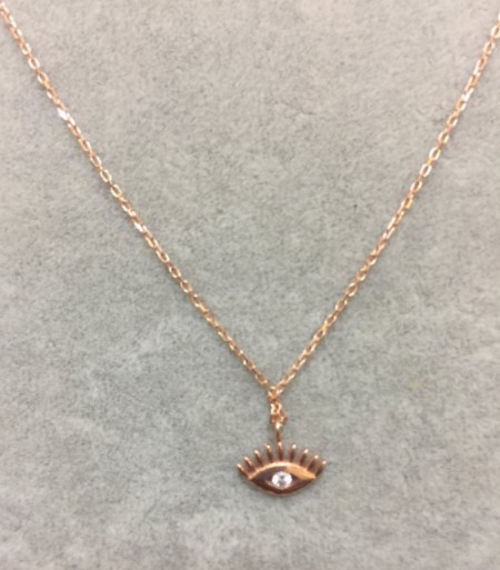 Close-up image of a gold-plated sterling silver evil eye necklace with a cubic zirconia centerpiece, hanging on a delicate chain.