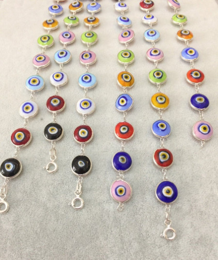 Multicolor evil eye bracelet with sterling silver links, featuring handcrafted Turkish design and vibrant glass beads, perfect for wholesale jewelry collections.
