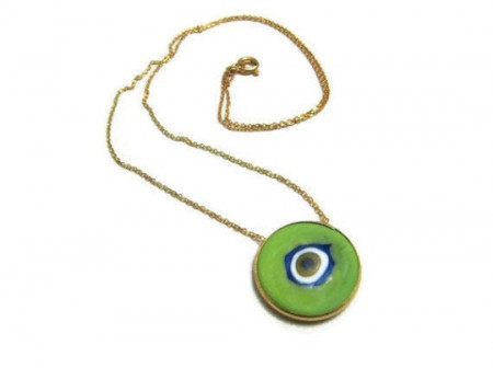 Green round evil eye pendant necklace crafted in sterling silver with a minimalist gold chain design.