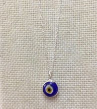 Dark blue evil eye necklace featuring a handmade glass bead pendant on a 925 sterling silver chain. Stylish and symbolic.