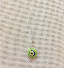 Green Turkish evil eye necklace featuring a handcrafted glass bead pendant on a 925 sterling silver chain. A symbol of protection and style.