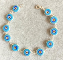 Turquoise evil eye beaded bracelet with sterling silver links and handmade vibrant beads, embodying Turkish tradition and elegance for wholesale buyers.