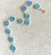 Turquoise evil eye beaded bracelet with sterling silver links and handmade vibrant beads, embodying Turkish tradition and elegance for wholesale buyers.