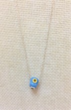 Turkish handmade evil eye bead necklace with a turquoise bead on a sterling silver chain. Elegant and protective design.
