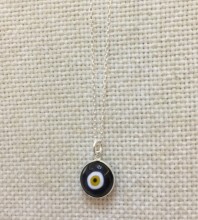 Black evil eye bead necklace with a sterling silver chain and handcrafted glass pendant.