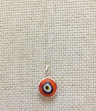 Red Nazar Boncugu evil eye necklace featuring a vibrant glass bead on a sterling silver chain.