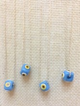 Turkish handmade evil eye bead necklace with a turquoise bead on a sterling silver chain. Elegant and protective design.
