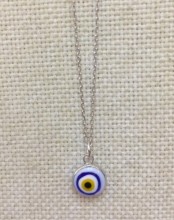 Turkish white evil eye bead necklace on a sterling silver chain, featuring a handcrafted symbolic design.