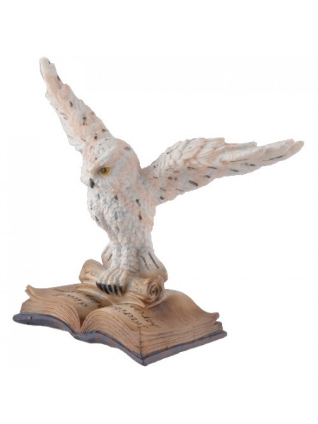 Statueta din rasina de culoare alb cu crem care intruchipeaza o bufnita cu aripile deschise stand pe o carte deschisa.