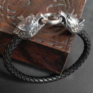 Bratara din piele naturala de culoare neagra cu impletitura ce are la capete cate un cap de lup din inox de culoare argintie si sunt conectati cu un cerc iar  circumferinta bratarii este de 19 cm.