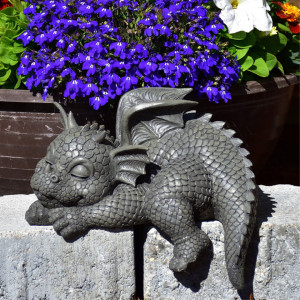 Statueta pentru gradina din rasina, in forma de dragon in pozitie de dormit, de culoare gri, cu dimensiunea de 22 cm.