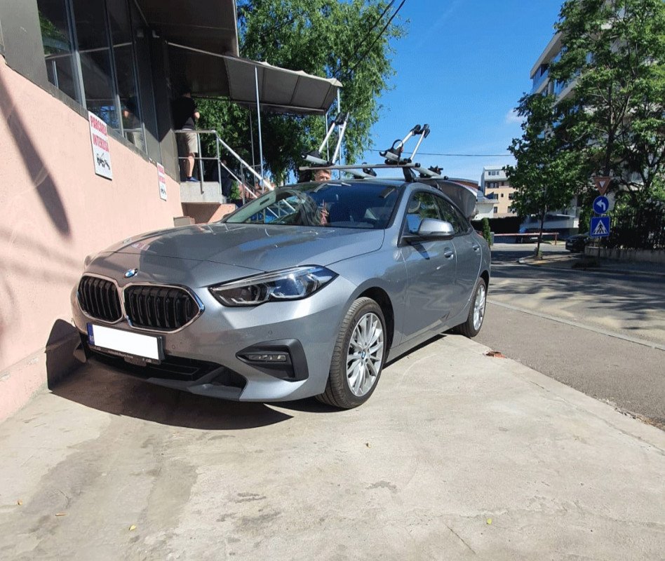 BMW 2 Series with Menabo Tema roof bars and two Menabo Juza bike racks
