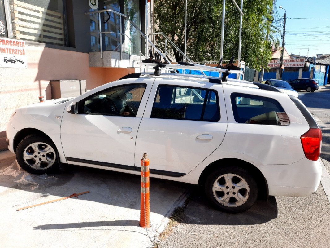 Dacia Logan MCV with Menabo Sherman roof bars and Menabo Juza bike racks