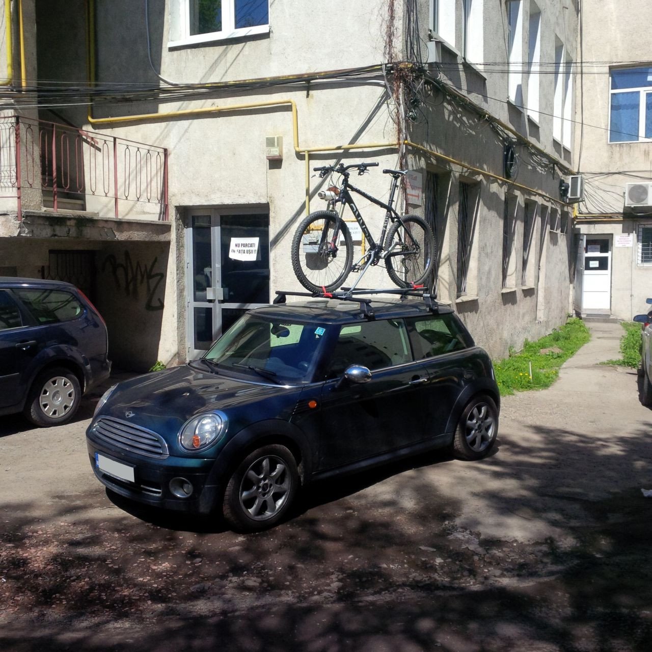 Mini Cooper with Menabo Tema Steel roof bars and a Menabo Iron bike rack