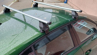 Peugeot 208 with Menabo Tema roof bars and a Thule FreeRide 532 bike rack
