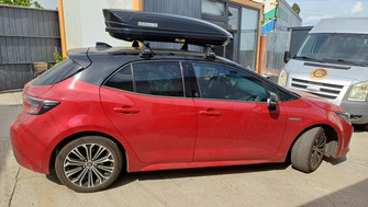 Toyota Corolla with Menabo Delta Black roof bars and a Menabo Mania 400 ABS Black roof box