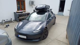 Tesla Model 3 with Menabo Dedicate OE roof bars and a Thule Motion 3 M Gloss Black roof box
