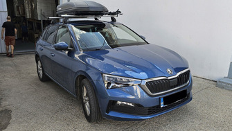 Skoda Scala with Menabo Tema roof bars and a Menabo Marathon Dark 400 roof box