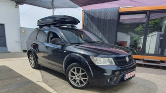 Fiat Freemont with Menabo Fender Black XL roof bars and a Menabo Mania 580 ABS roof box