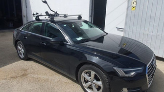 Audi A6 with Thule Edge Clamp Silver roof bars and a Thule ProRide 598 bike rack
