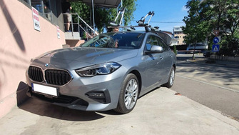BMW 2 Series with Menabo Tema roof bars and two Menabo Juza bike racks