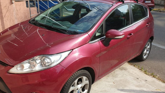 Ford Fiesta with Menabo Tema roof bars and a Menabo Marathon roof box