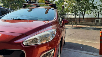 Peugeot 308 with Menabo Tema roof bars and Thule ProRide 598 bike racks