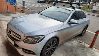 Mercedes-Benz C-Class with Menabo Delta roof bars and a Menabo Yelo 6 ski and snowboard rack