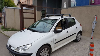 Peugeot 206 with Menabo Tema roof bars and a Menabo Huggy bike rack