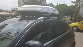 Audi Q3 with Menabo Lince roof bars and a Menabo Diamond roof box