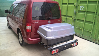 Volkswagen Caddy with a Menabo Race 4 towbar bike rack and a Menabo Boxxy cargo box