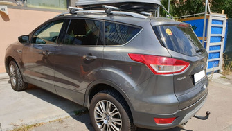 Ford Kuga with Menabo Sherman XL roof bars and a Menabo Mania roof box