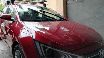 Hyundai Elantra with Menabo Delta Silver roof bars and a Menabo Juza bike rack