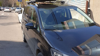 Volkswagen Touran with Menabo Sherman XL roof bars and a Menabo Mania roof box