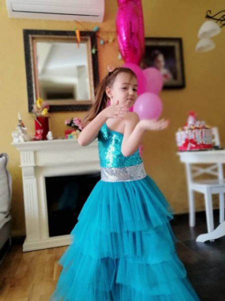 Beautiful tulle ruffles and shimmering girls turquoise dress