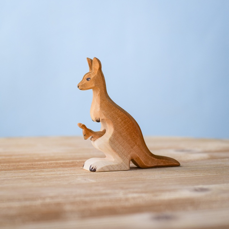 Handmade wooden mama kangaroo with joey on wooden surface