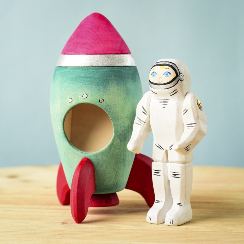 Hand-painted wooden rocket with a removable astronaut figure.