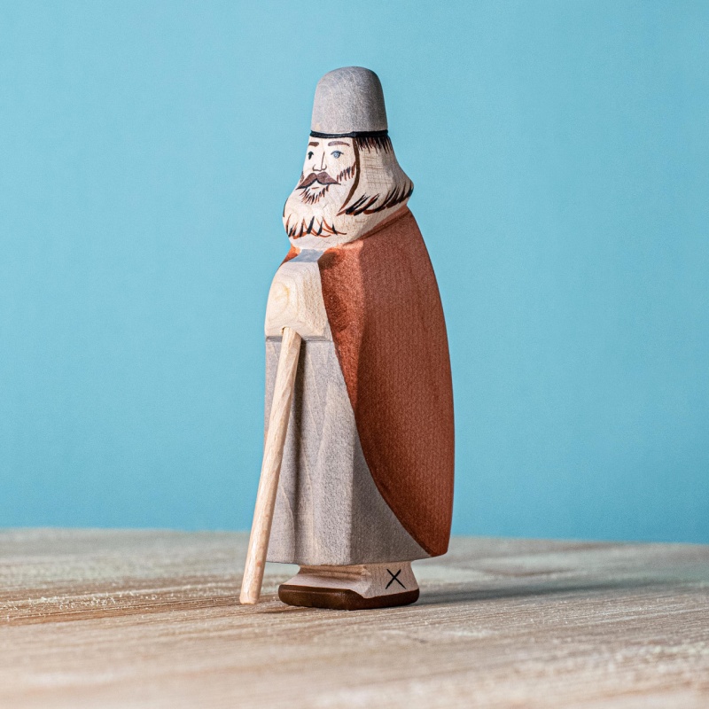 Image of the &quot;Shepherd Standing with Beard&quot; figurine standing proudly on a natural wooden surface.