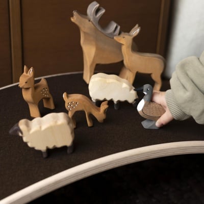 A child drawing a picture of the stag toy, inspired by its design.
