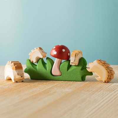 A child using the mushroom in pretend play, pretending to pick it or hide it.