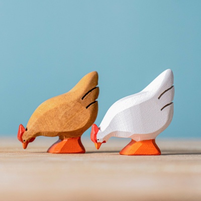 The BumbuToys White Hen incorporated into a farmyard play scene with other wooden animals and accessories.