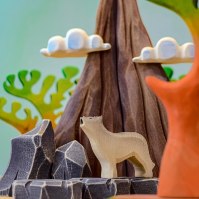 The howling wolf toy sitting on a shelf in a child's room.